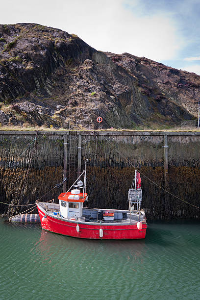 Harbour Wall and Fishing Boat stock photo