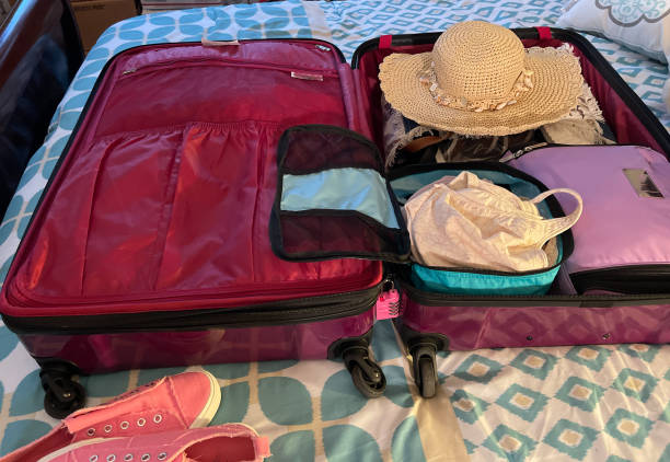 istock Suitcase packed ready for travel on a bed 1785081288