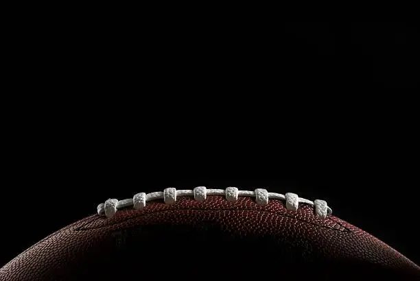 Close up of a football over black background