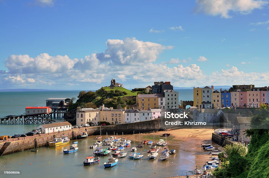 View of Tenby Harbour, with Castle Hill. "Picturesque view of boats in Tenby Harbour, with its clusters of colourful painted houses, and Castle Hill" Tenby Stock Photo