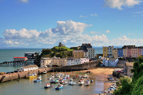 View of Tenby Harbour, with Castle Hill. "Picturesque view of boats in Tenby Harbour, with its clusters of colourful painted houses, and Castle Hill" wales photos stock pictures, royalty-free photos & images