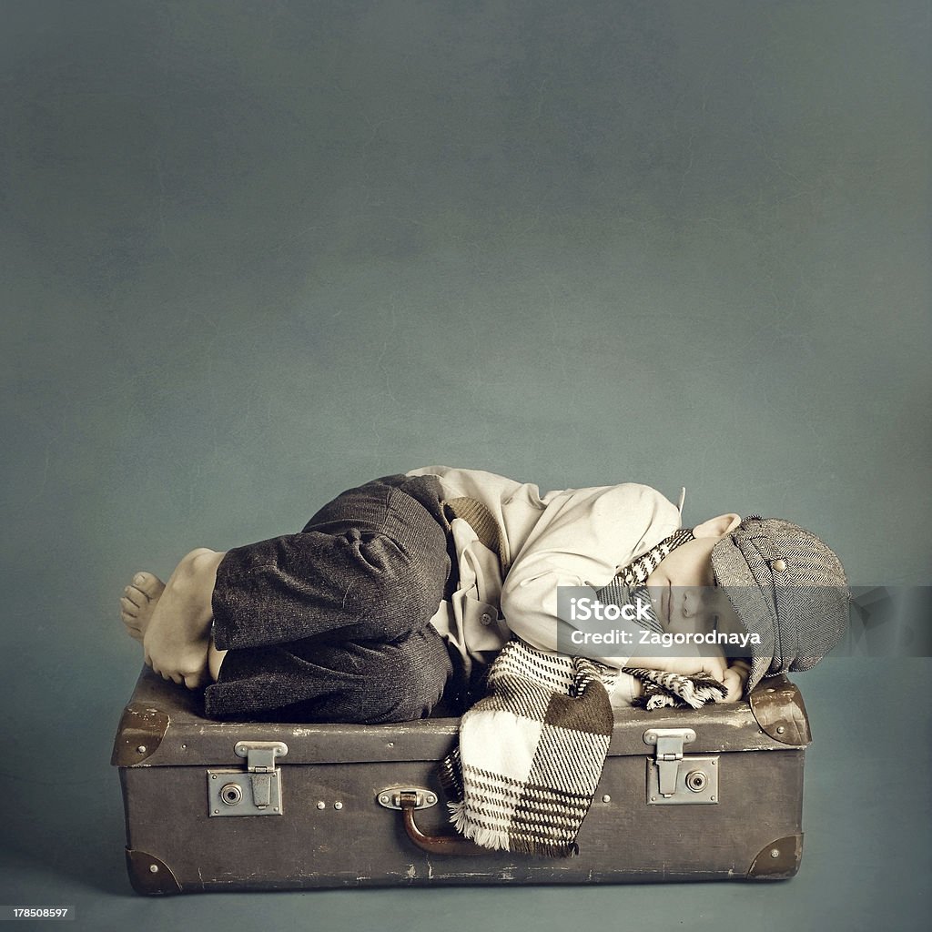 boy sleeping on a suitcase Bag Stock Photo