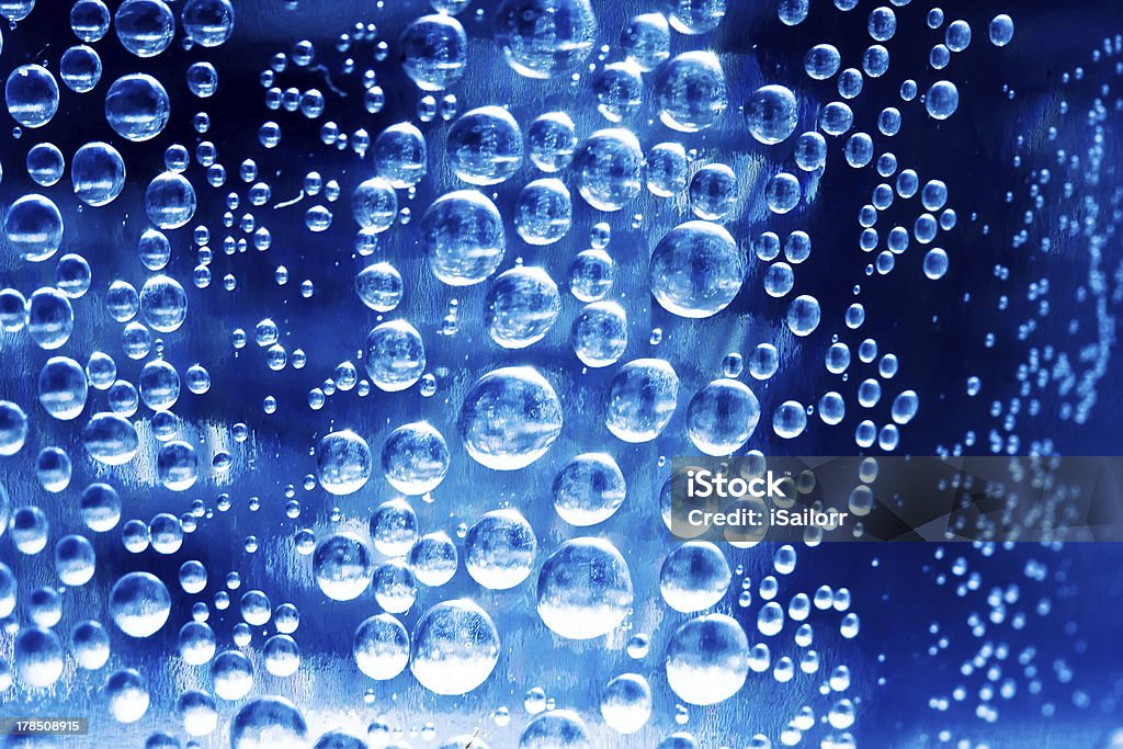 Bubbles Bubbles in glass of water on a blue background Abstract Stock Photo