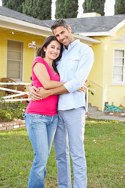 istock Couple Standing Outside Suburban Home 178508918