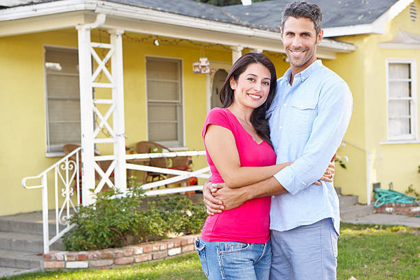 istock Couple Standing Outside Suburban Home 178509458