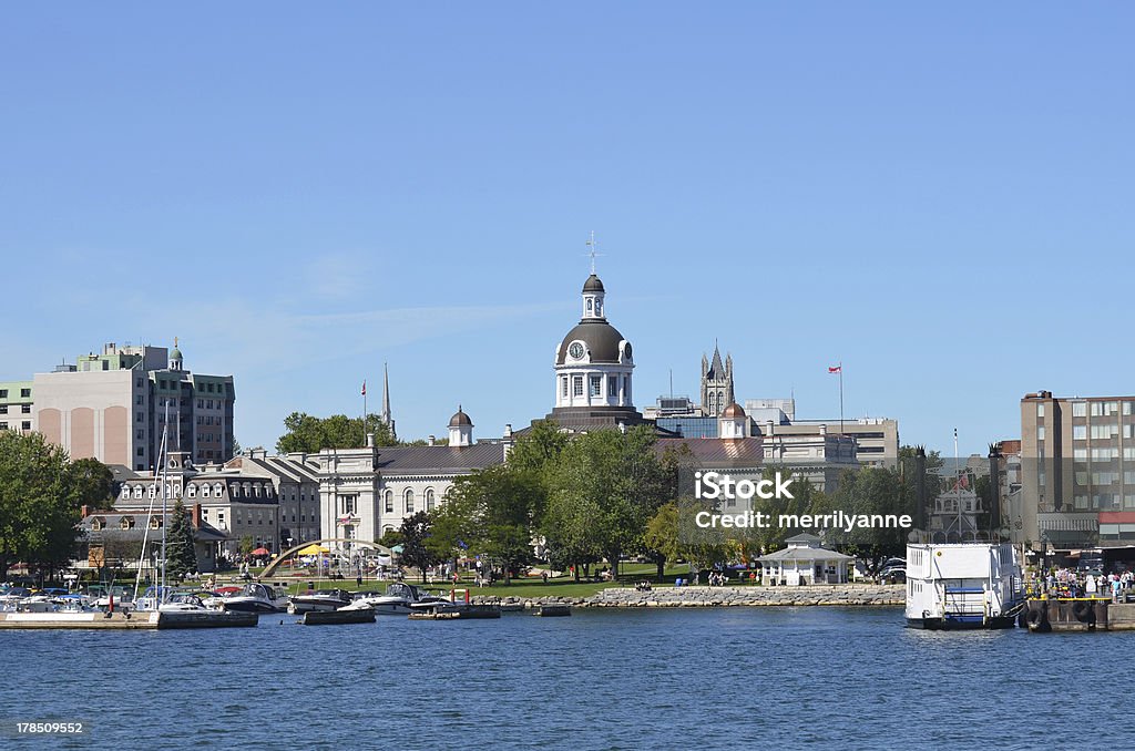 City Of Kingston Ontario Canada from the Water This photo shows City Hall in the City of Kingston Ontario Canada from the water.  It shows the trees and fountain in Confederation Park in front of the domed City Hall building.  The dome also has a clock and bell tower.  A marina with boats is in front of the park also.  A large tour boat sits waiting for tourists to tour the Thousand Islands.  Kingston is on Lake Ontario where the St. Lawrence and Rideau Rivers meet. Kingston - Ontario Stock Photo