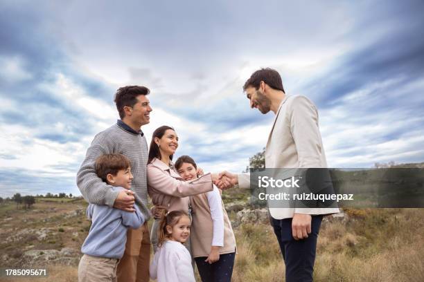 Real Estate Agent Showing Family Allotment To Build Their New Home Stock Photo - Download Image Now