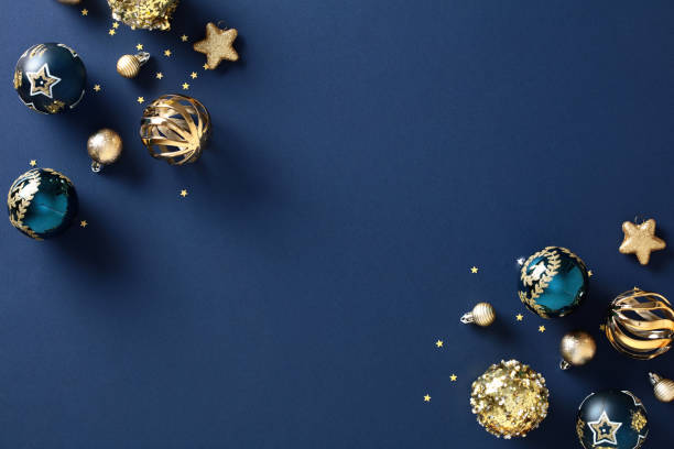istock Chic Christmas composition with gold bauble, blue background, and elegant design - Festive holiday card concept 1785099928