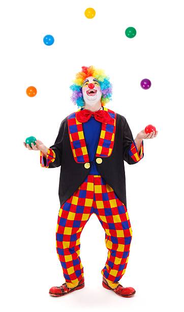 Clown making funny gesture in front of a red curtain isolated on white background