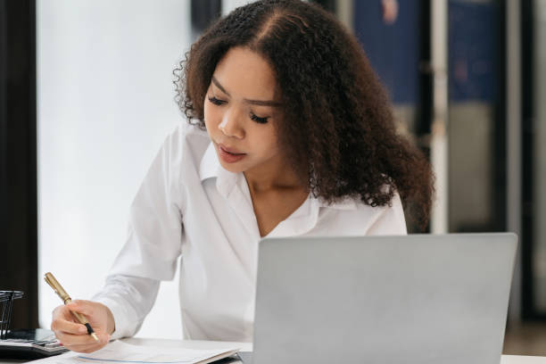 istock Businesswomen hand working with tablet and laptop computer with documents on office desk. 1785105709