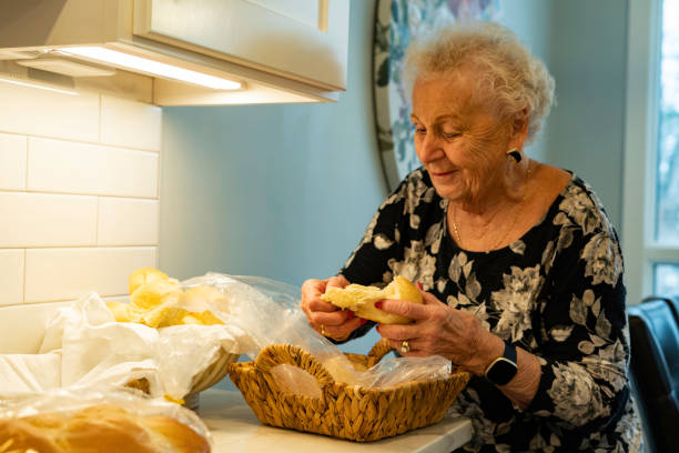 istock Woman sneaks a dinner roll before Thanksgiving 1785105740