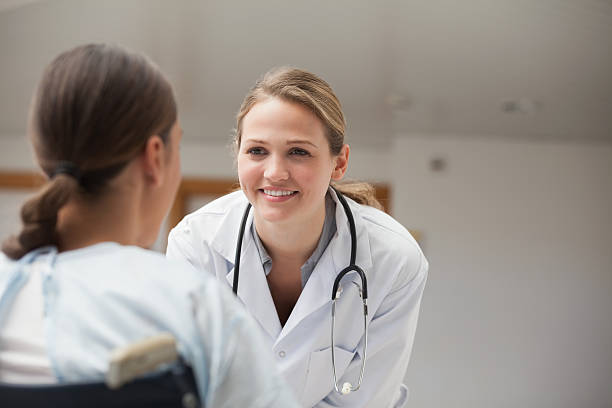 istock Smiling doctor looking at patient on a wheelchair 178510703