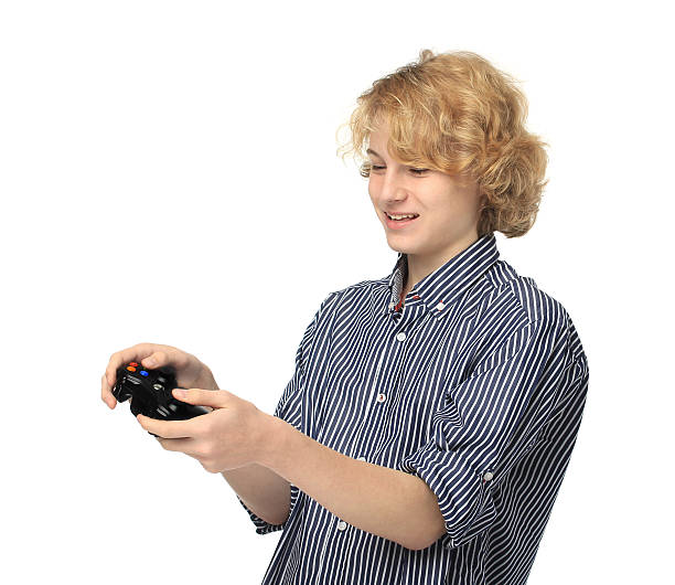 10 代の少年が game.smiling - blond hair control electrical equipment excitement ストックフォトと画像