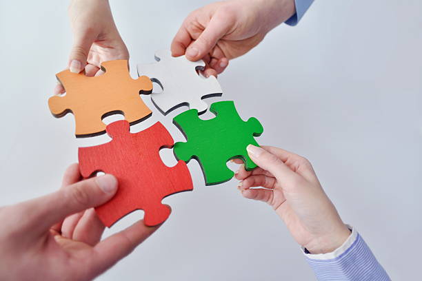 istock Group of business people assembling jigsaw puzzle 178511284