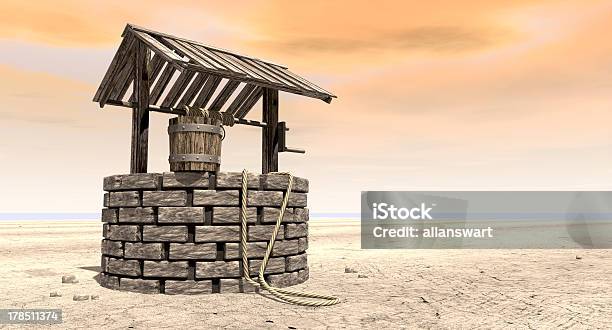 Wishing Well With Wooden Bucket On A Barren Landscape Stock Photo - Download Image Now