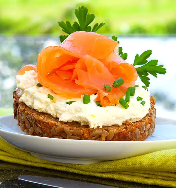 Wholemeal bread with quark spread and salmon.Breakfast. Sandwich With salmon fillet.