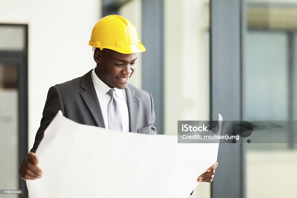 african american businessman looking at blueprint happy african american construction businessman looking at blueprint Hardhat Stock Photo