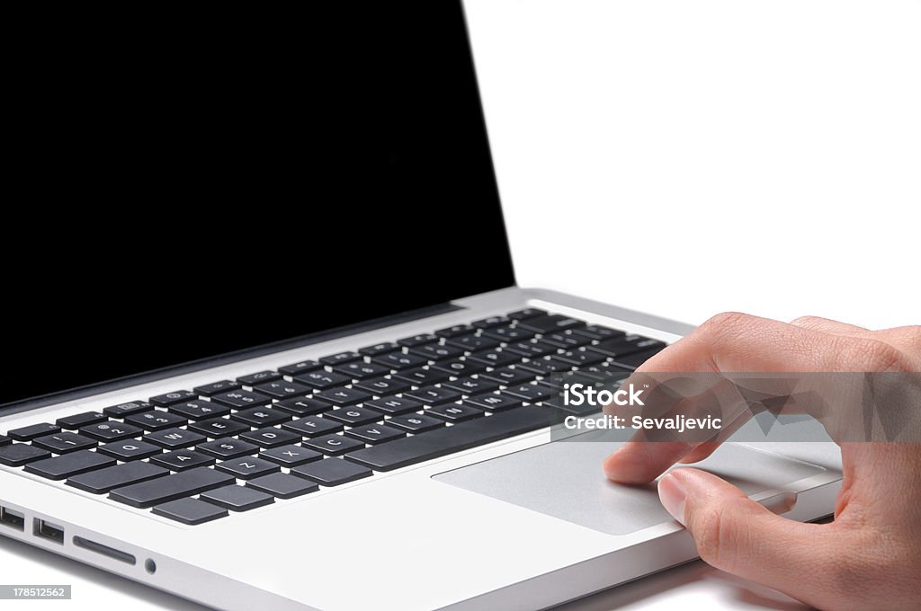 Laptop work "Using a laptop, finger on touchpad" Black Color Stock Photo