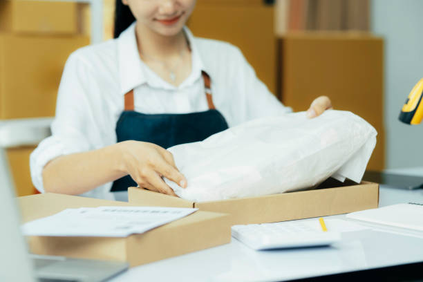 istock Small business owner packing clothes in the box at workplace. 1785127348