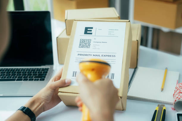 Scanning parcel barcode before shipment. stock photo