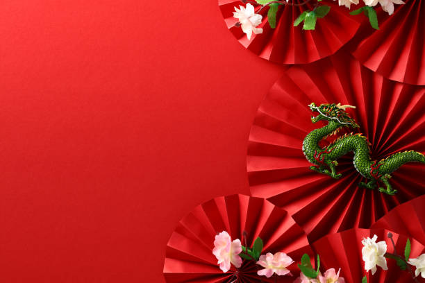 istock Abstract composition with paper fans, dragon, sakura on red backdrop, celebrating Chinese New Year 2024. Asian art and culture in a festive design. 1785130273