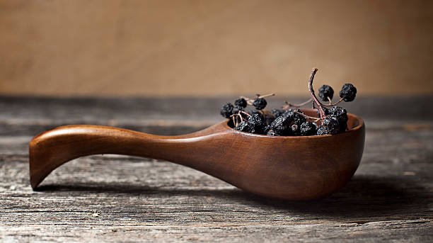 istock Dried aronia berries in a wooden spoon 178513452