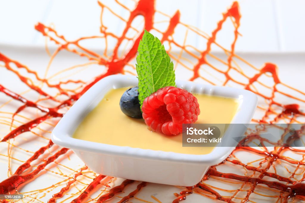 Vanilla custard Small dish of vanilla custard topped with fruit Blueberry Stock Photo