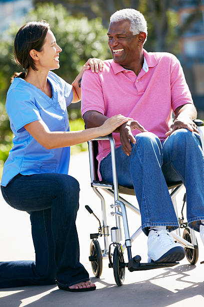 istock Carer Pushing Senior Man In Wheelchair 178514085