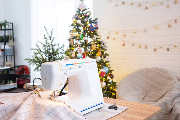istock Sewing process on a sewing machine, a needle with a thread and a holder close-up stitch the white checkered fabric. Preparation for Christmas and new year, textiles for cozy in festive decor interior 1785143111