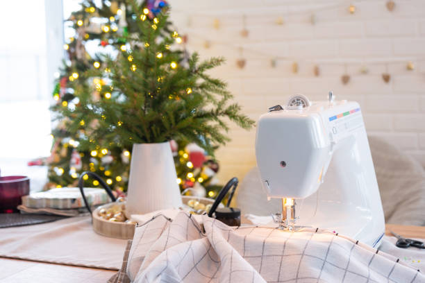 istock Sewing process on a sewing machine, a needle with a thread and a holder close-up stitch the white checkered fabric. Preparation for Christmas and new year, textiles for cozy in festive decor interior 1785143117