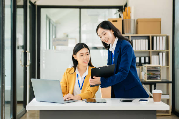 istock Asian working together on a project two young business colleagues working 1785145967