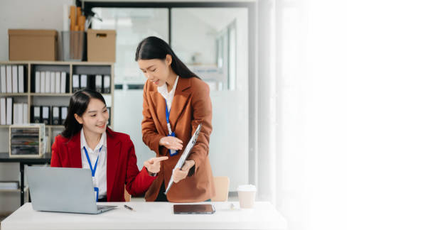 istock Asian working together on a project two young business colleagues working 1785146209