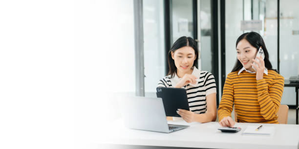 istock Two Asian woman discuss investment project working and planning strategy 1785146492