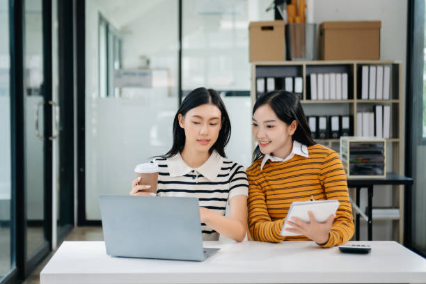 istock Two Asian woman discuss investment project working and planning strategy 1785146495