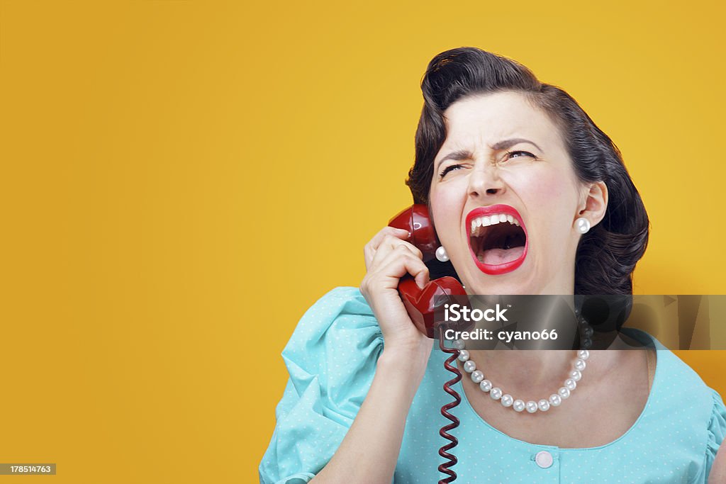 Angry woman screaming on the phone Vintage Woman shouting into telephone 1950-1959 Stock Photo