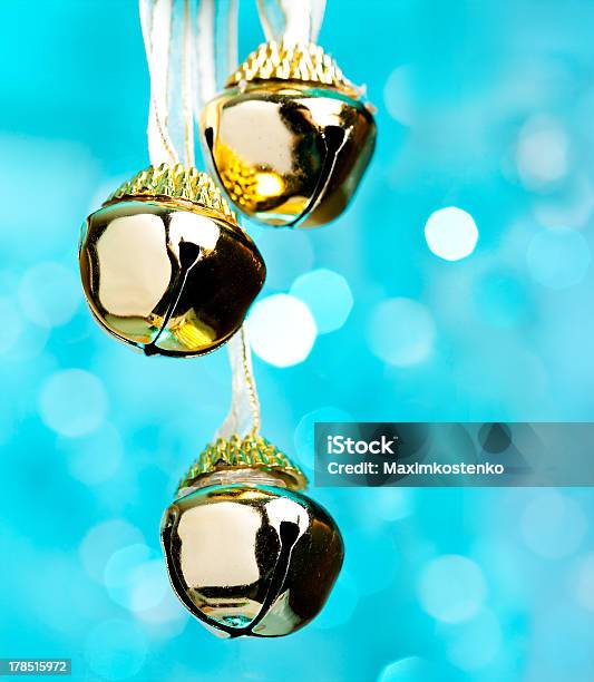 Christmas Bells With Ribbon Defocused Blue Lights On Background Stock Photo - Download Image Now