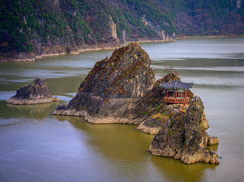 Danyang Landmark Attractions called Dodamsambong, Three Peaks Island in the Lake in Korean or Chinese words, a group of 3 jagged rock formations rising out of  Chungju River in South Korea