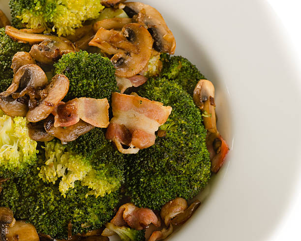 istock Broccoli sauteed with bacon, onion and mushrooms in white plate 178517754