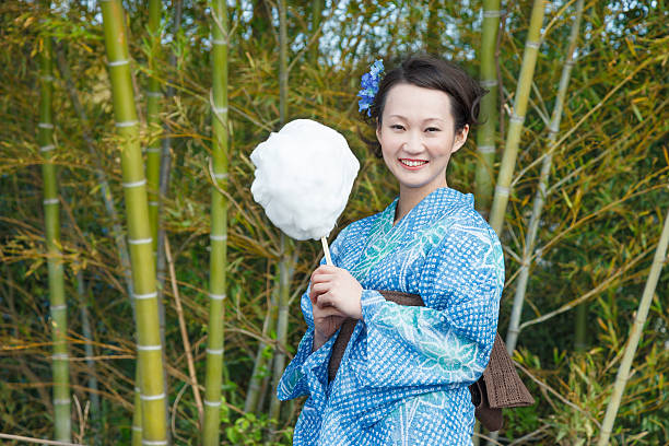 Asian kimono woman with bamboo grove Kimono woman with cotton candy knot garden stock pictures, royalty-free photos & images