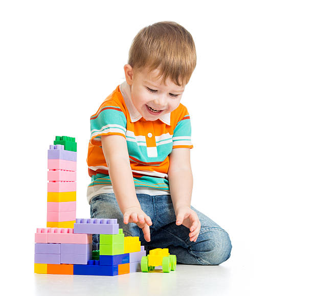 istock cheerful child boy playing with construction set over white background 178519452