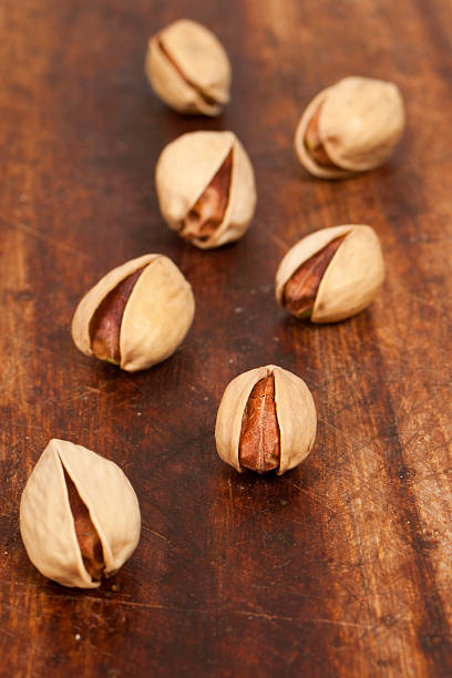 istock pistachio on wooden background 178519594