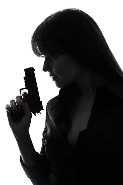 istock sexy detective woman holding gun silhouette 178519629
