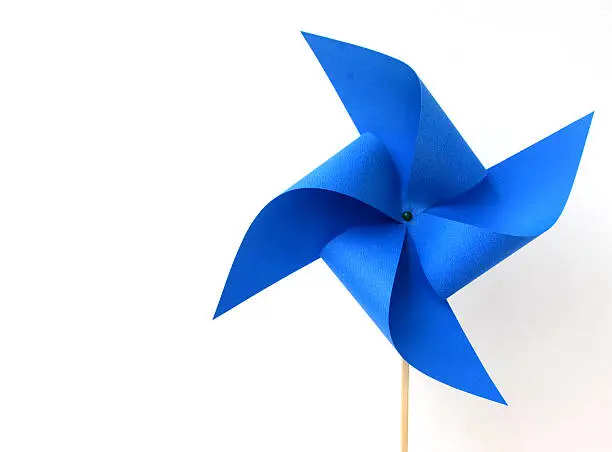 Photo of A blue paper windmill on a white background