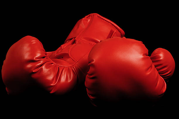 istock Vintage boxing gloves emerging from black background 178519746