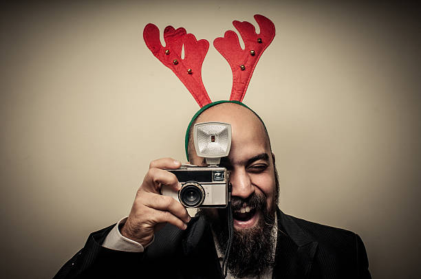 christmas bearded man holding old camera stock photo