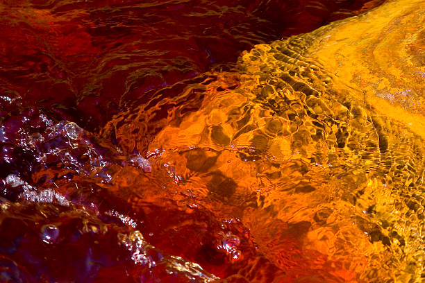 Rio Tinto, Spain "The RA-o Tinto (red river) is a river in southwestern Spain. As a possible result of the mining, RA-o Tinto is notable for being very acidic (pH 2) and its deep reddish hue is due to iron dissolved in the water. This river has gained recent scientific interest due to the presence of extremophile aerobic bacteria that dwell in the water." copper mine photos stock pictures, royalty-free photos & images