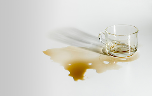 Coffee from a sloppy glass on a white background scene