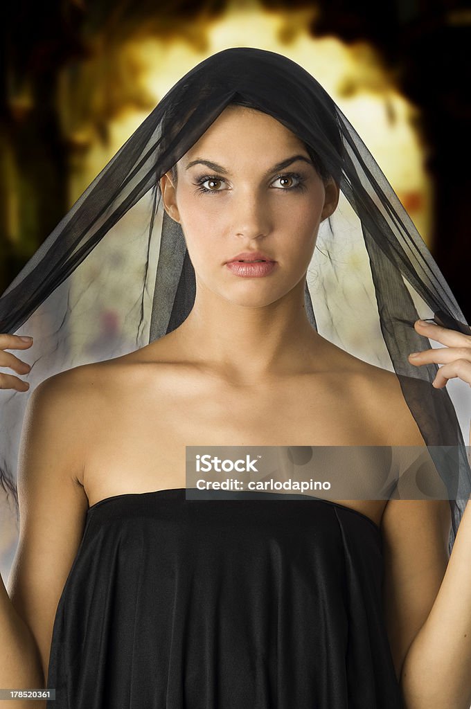 woman in black beautiful woman with a black veil on her head like black wife Adult Stock Photo