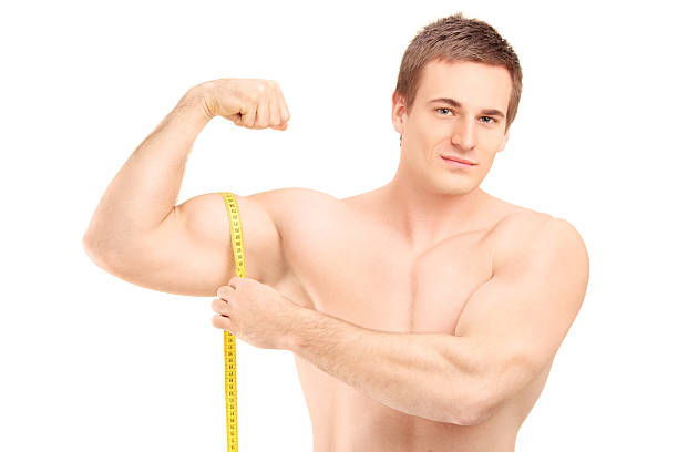 Close-up of a man measuring his biceps with a tape measure Stock Photo -  Alamy