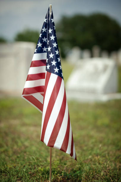 istock American flag flying in cemetery on Memorial Day 1785215174